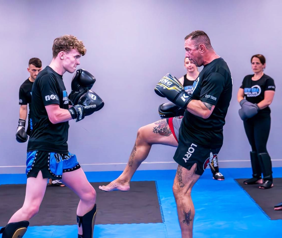 Coach training a young student with focus mitts